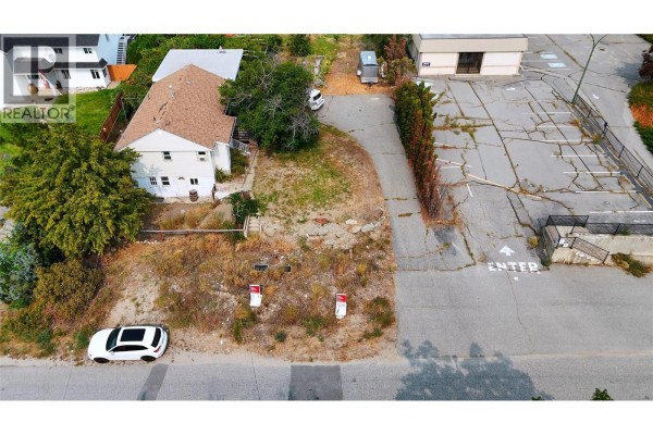 Top-down view of a residential property with a driveway and adjacent commercial space. - 9704 & 9700 Julia Street, Summerland
