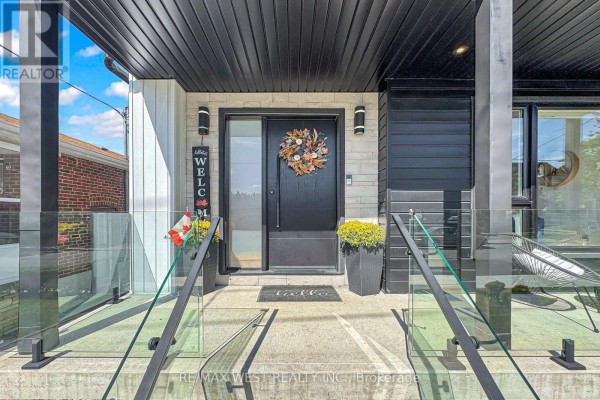 Close-up of the front door entrance with glass railings on the stairs and welcome mat. - 972 Castlefield Avenue, Toronto