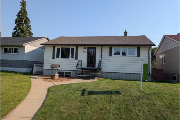 Exterior of a beige bungalow with a light brown roof and grass lawn. - 9747 66 Av Nw, Edmonton