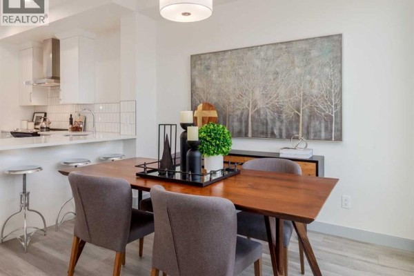 Dining area with wooden table, gray chairs, and decorative centerpiece - 975 Edgefield Avenue, Strathmore