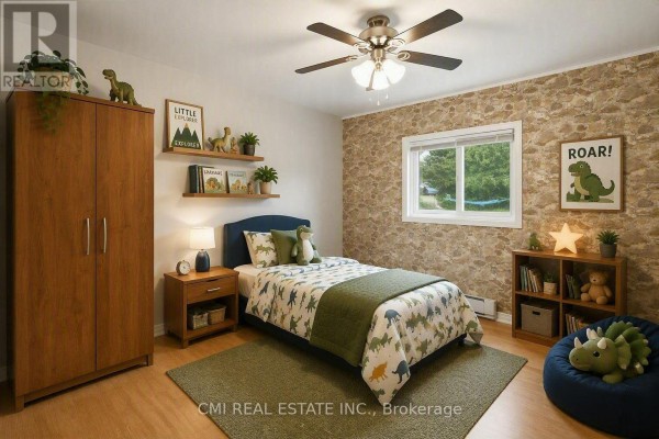 Bedroom with dinosaur decor, stone accent wall, and ceiling fan - 977 County Rd 38 Trent Hills