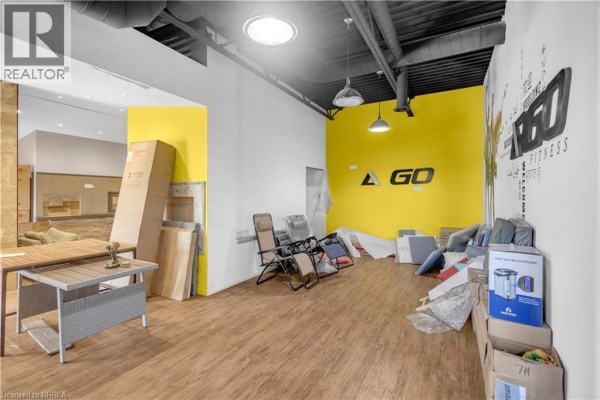 Wide view of a workshop with metal stock, welding equipment, and storage shelves. - 978 Bishop Street N, Cambridge
