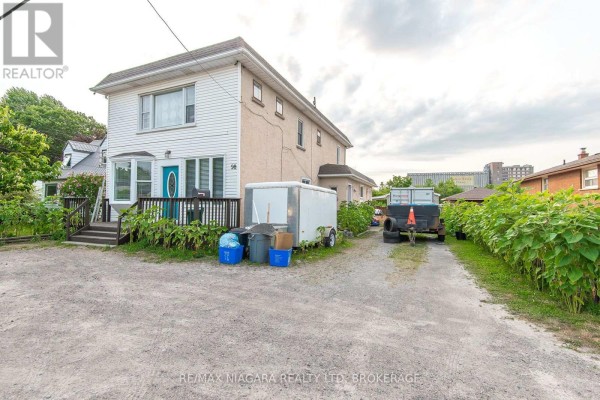 Living room view with a TV unit and access to adjacent rooms - 98 Chippawa Road, Port Colborne