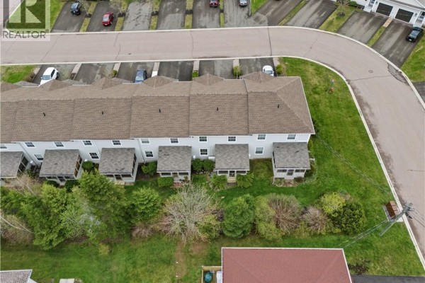 Aerial perspective of a suburban neighborhood showing rows of townhouses and a school. - 98 Firmin Crescent, Dieppe