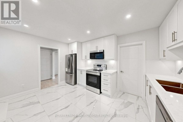 White kitchen with stainless steel appliances and marble tile flooring. - 98 Thornton Avenue, Bradford West Gwillimbury