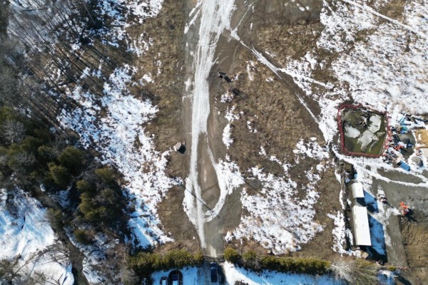 Aerial shot of a snow-covered lot with a dirt road and parked vehicles. - 980 Rue Notre-dame, Gatineau