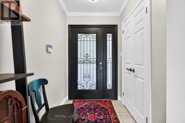 Interior entryway with a black metal-detailed front door, tiled floor, and white double doors. - 984 Highway 8 Highway, Hamilton