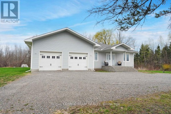 Front exterior of a light gray, single-story home with light gray siding and white trim. - 986 South Gower Drive, North Grenville