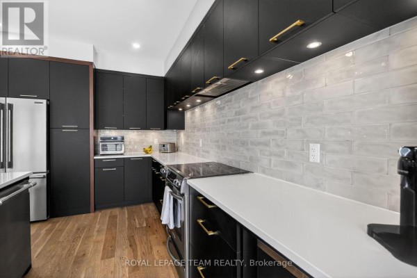 Close-up of modern kitchen cabinetry, white subway tile backsplash, and stainless steel appliances. - 988 Beckton Heights, Ottawa