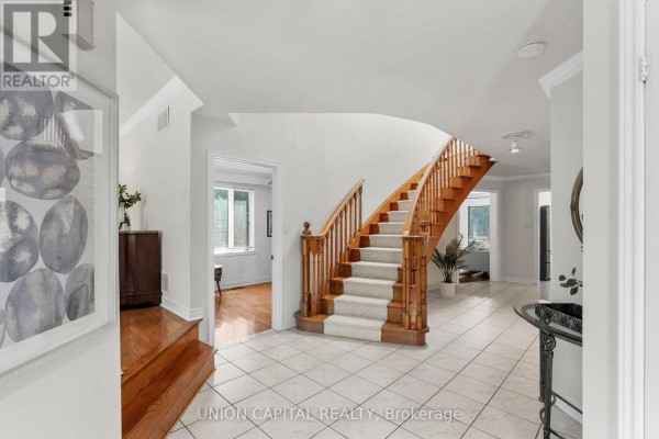 Living room with sofas, bay window, hardwood floor, and abstract artwork. - 99 Abitibi Avenue, Toronto