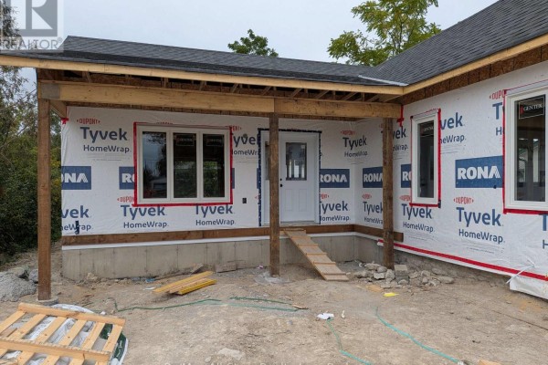 Close-up of the covered porch entrance of the house under construction. - 99 St Patrick Street, Kawartha Lakes