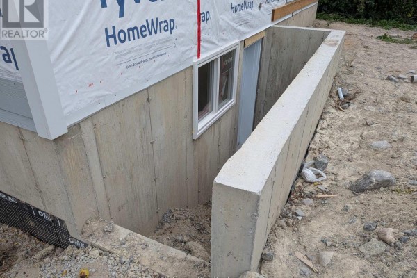 Concrete foundation and basement entrance of the house under construction. - 99 St Patrick Street, Kawartha Lakes