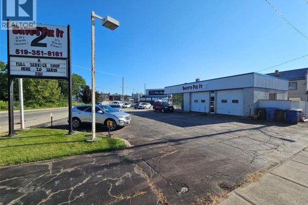 Commercial building with "Dave's Fix It 2" sign and service bay doors, cars parked nearby. - 99 Thames Street, Chatham