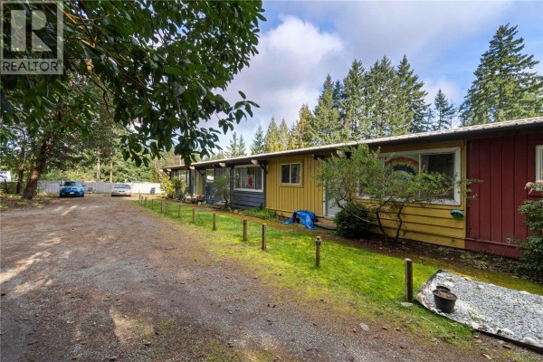 Front view of the building with multiple units and colorful siding. - 992 Allenby Rd, Errington