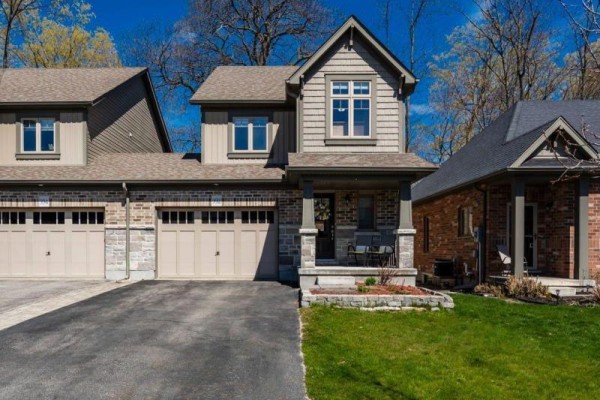 Street view of a townhouse complex showing multiple units with varying exterior materials. - 992 Cook Drive, Midland