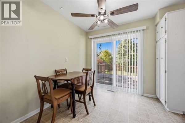 Dining area with a table and chairs beside a sliding glass door leading to a backyard patio. - 993 Highway Drive Unit# Upper, Sarnia
