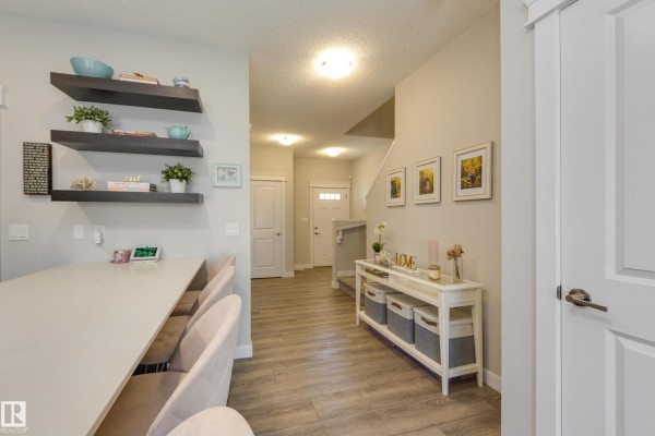 View from the kitchen island towards the entryway and living area, featuring a console table. - 9932 223 St Nw, Edmonton