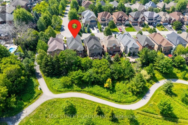 Aerial view of houses along a street bordering a park pathway with a red marker. - 995 Nellie Little Crescent, Newmarket