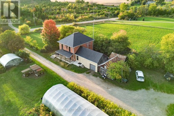 Overhead view of a red brick house with attached garage and rural landscape. - 995305 Mono Adjala Townline, Adjala Tosorontio