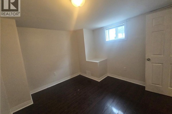 Empty room with dark wood floors, a window, and a door. - 996 Queensdale Avenue E Unit# B, Hamilton