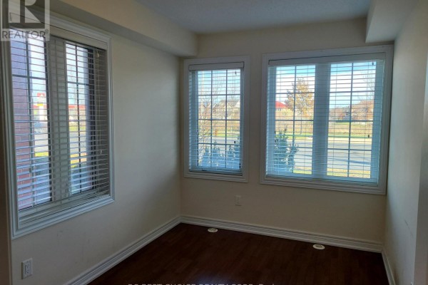 Interior room with dark hardwood floors and two windows with blinds showing exterior view. - 9982 Mccowan Road, Markham