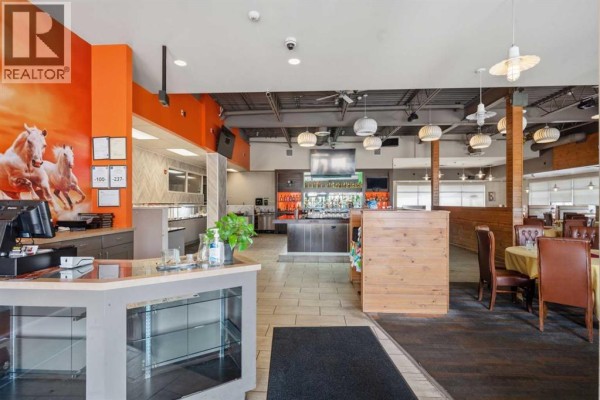 Interior view of a restaurant showing a bar area, dining tables, and buffet station. - 9995 178 Street Nw, Edmonton