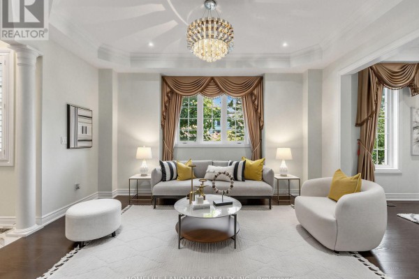Living room with a grey sofa, two armchairs, a large white rug, and a crystal chandelier. - 9a Anglin Drive, Richmond Hill
