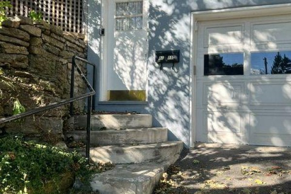 Close-up of concrete steps, stone wall, and white front door with garage. - A - 11 Kippewa Drive, Ottawa