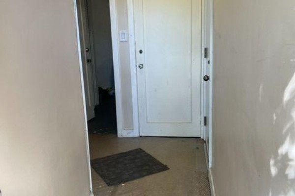 Interior hallway with beige walls, white doors, and a dark mat. - A - 11 Kippewa Drive, Ottawa