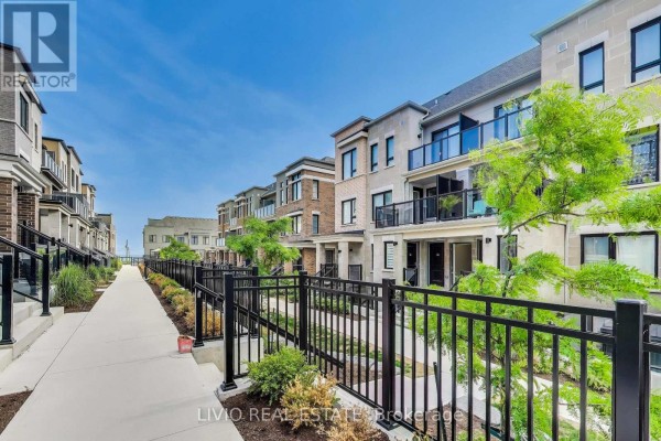 View of the courtyard with townhouses and decorative plants - A - 14 Lookout Drive, Clarington