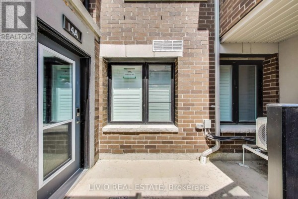 Ground-level view of townhouse entrance with window and seating area - A - 14 Lookout Drive, Clarington