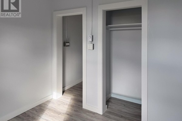 Hallway with two doorways, one leading to another room and one to a closet. - A - 23 Peter Street S, Orillia