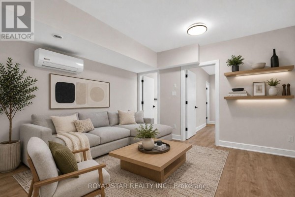 Living room with a sectional sofa, coffee table, armchair, and decorative shelves. - A - 526 Mutual Street, Ottawa