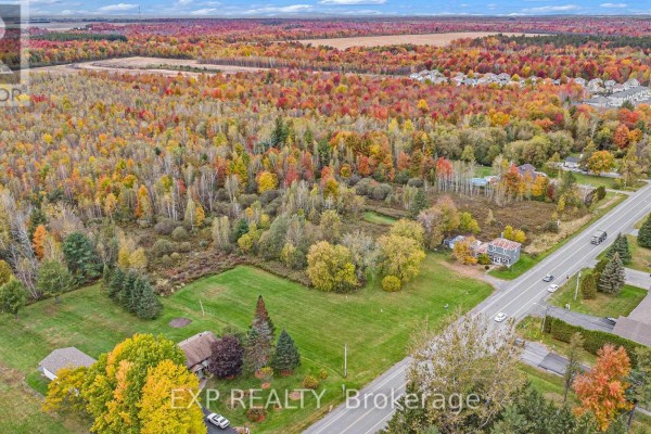 Aerial perspective of the landscape with vibrant autumn colors and nearby roads. - A - 620 Limoges Road, The Nation