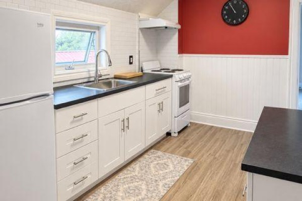Compact kitchen with white cabinets, stainless steel sink, white refrigerator, and stove. - A - 9 Francis Street W, Kawartha Lakes