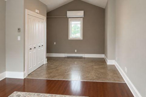 Room with neutral walls, white bi-fold closet doors, and a window. - A - 9 Francis Street W, Kawartha Lakes