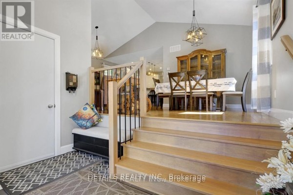 View of the dining room and staircase from the entrance hallway. - A - Upper Unit - 2565a Page Road, Ottawa
