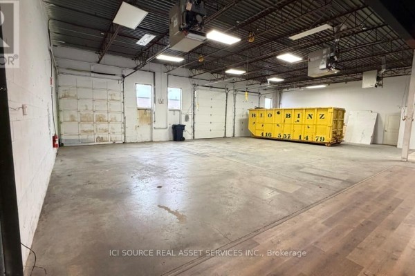 Large open warehouse space with high ceilings and yellow dumpster - A-south Unit 31-33 - 18 Strathearn Avenue, Brampton