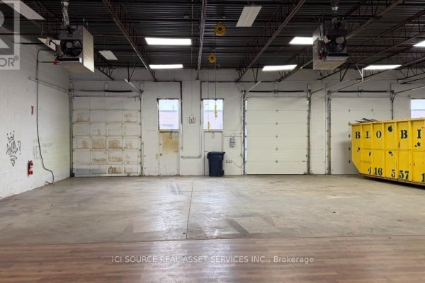 Warehouse interior with two garage doors and concrete flooring - A-south Unit 31-33 - 18 Strathearn Avenue, Brampton