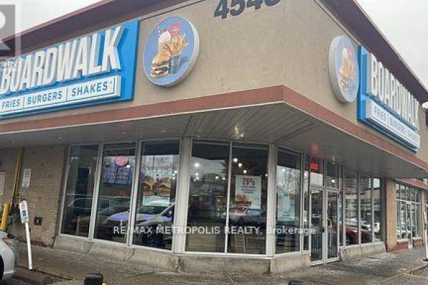 Corner view of Boardwalk restaurant showing entrance and large windows. - A010 - 4543 Kingston Road, Toronto