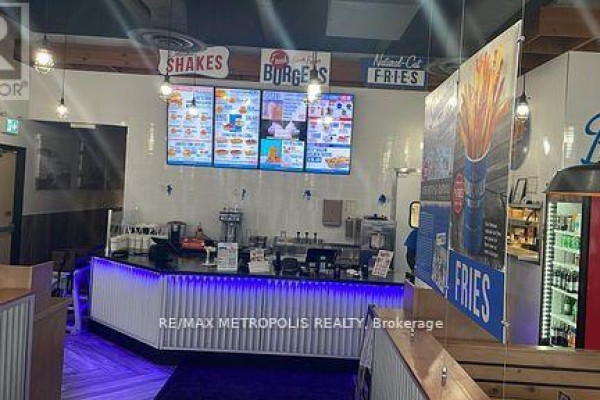 Interior counter area with menu boards, beverage station, and blue LED lighting. - A010 - 4543 Kingston Road, Toronto