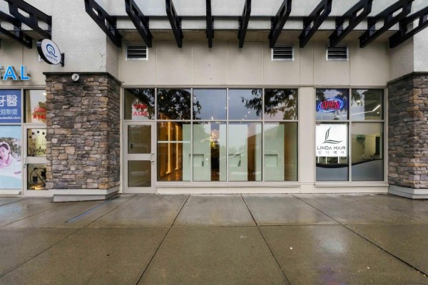 Storefronts with large glass windows, glass doors, and stone facade details. - A145 20487 65 Avenue, Langley