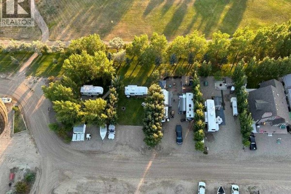 Open land with gravel driveway, RVs, and trees lining the area. - A2 Forty Mile Park, Rural Forty Mile No  8, County Of