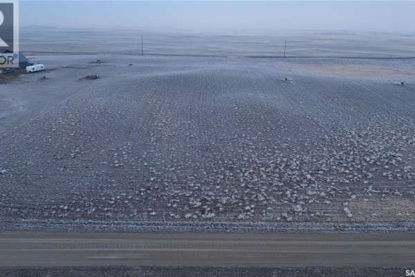 Frosted fields with a dirt road in the foreground and a small white structure on the left. - A2 Valley View Estates, Longlaketon Rm No  219