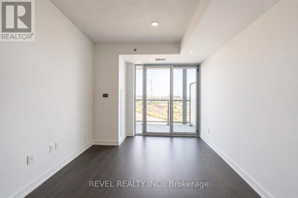 Spacious, brightly lit fitness studio with wood floors, mirrors, large windows, and mounted television screen. - A223 - 3210 Dakota Common, Burlington