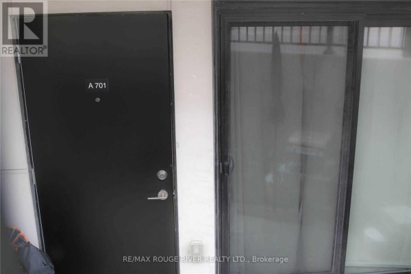 Kitchenette with white cabinets, stainless steel refrigerator, and fold-down table. - A701 - 5309 Highway 7 Road, Vaughan