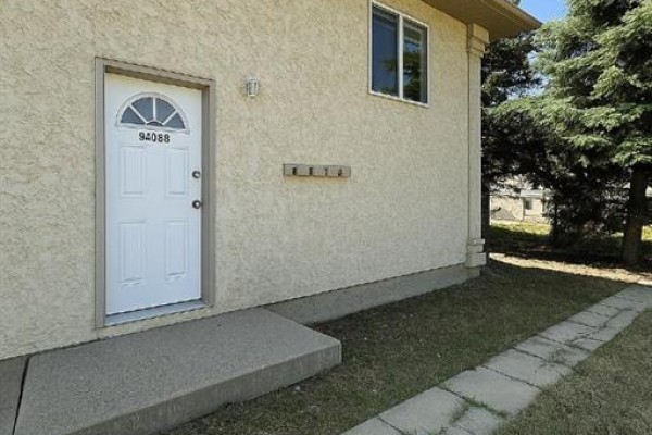 Close-up of a white front door with house number 9408. - B, 9408 100 Avenue, Grande Prairie