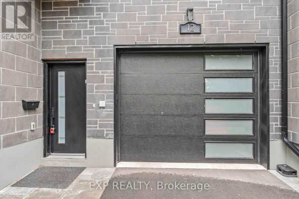 Close-up of the front door and garage door of a modern house at number 12. - B - 12 Sylvester Street, Ottawa