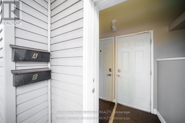 View of two mailboxes labeled A and B beside two white doors. - B - 1896 Featherston Drive, Ottawa