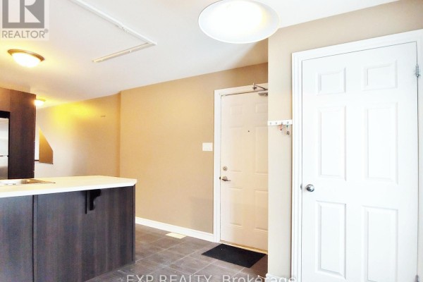 Close-up of entrance with stairs leading to the front door and brick details - B - 605 Chapman Mills Drive, Ottawa